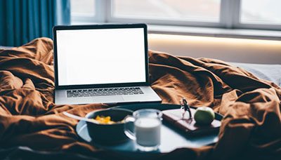 Włączony laptop na łóżku mobile